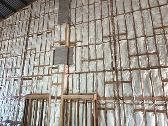 a large framed and insulated wall inside the multipurpose room