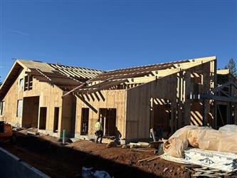 a wood framed building with a large shed roof and exposed rafters