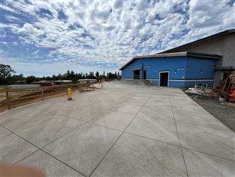 A large expanse of concrete behind the multipurpose room