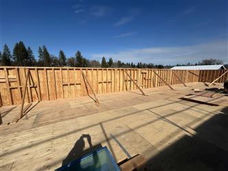 plywood roofing with a short wood framed parapet wall with wood bracing installed