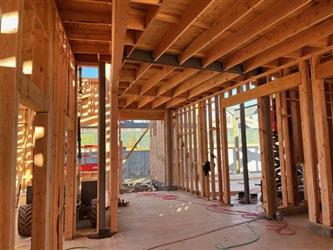 a view in a building showing ceiling josts and framing above a concrete slab