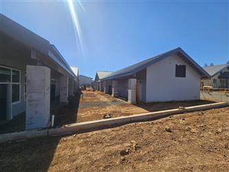 2 classroom buildings with blue painted horizontal siding and concrete columns.