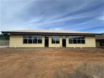 the South side of Building B showing new window glazing and siding