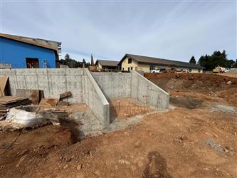 Large retaining walls that are set for concrete stairs to be installed