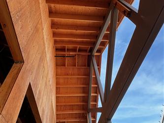 The overhang of a new classroom building at Paradise Elementary with clouldy skies