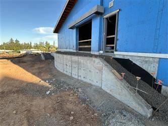 A retaining wall and gravel fill for the concrete stage behind the multipurpose room