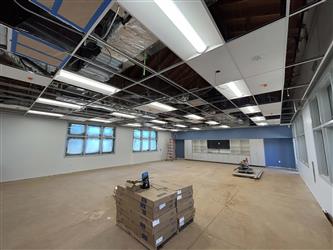 a classroom interior with partial t-bar ceiling, painted white and blue