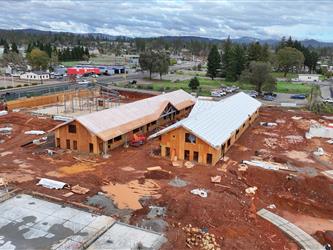 An aerial view facing East of the two new classroom wings that have been framed.