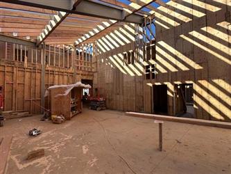 a large wood framed class room with high ceiling and exposed rafters