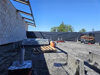 the roof over the main office area showing roof sealant and ventilation pipes penetrating the roof