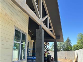 a classroom exterior with steel framing and unpainted siding