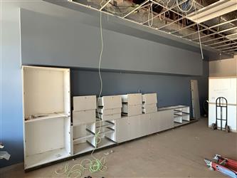 a classroom interior painted and currently having white cabinets installed