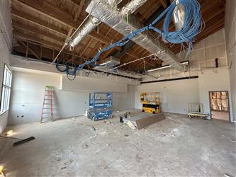the interior of a classroom with dryway and exposed ceiling and network wiring